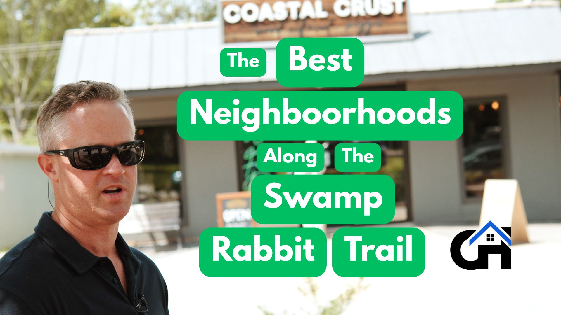 Cyclists and walkers enjoying the Swamp Rabbit Trail surrounded by greenery and nearby Greenville neighborhoods.
